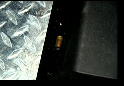 (Shell casing on floor by driver's seat, Dunn's car.)