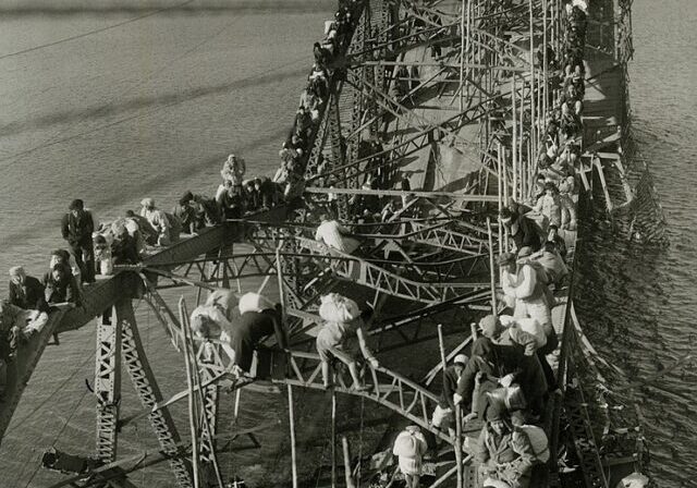 Public Domain https://commons.wikimedia.org/wiki/File:Flight_of_Refugees_Across_Wrecked_Bridge_in_Korea.jpg